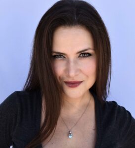 Photo of caucasion female with brown hair and brown blouse