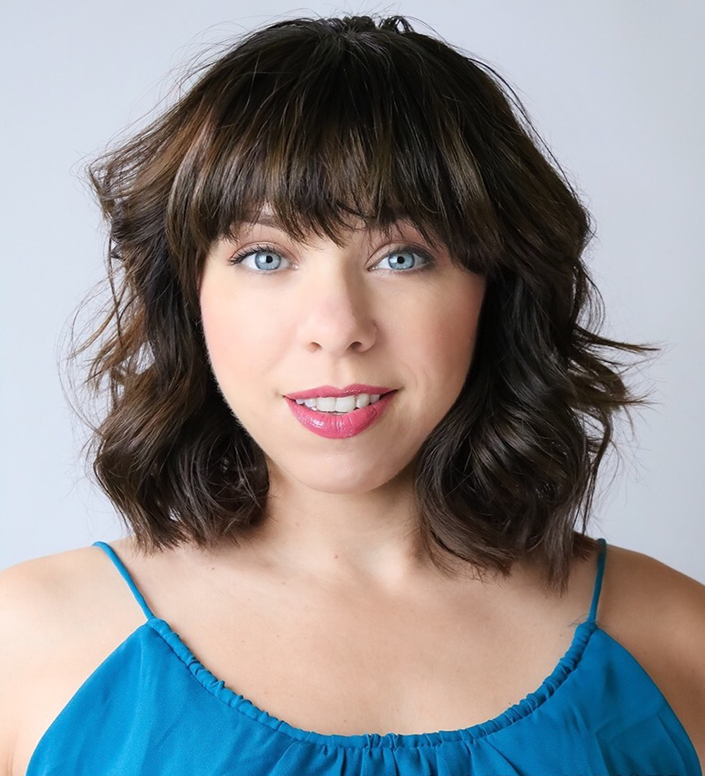 Photo of caucasion female with brown hair and blue blouse